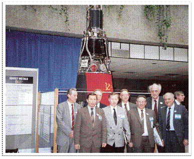 Figure 1:     Soviet scientists led by Krasnaya Zvezda Director Georgiy Gryaznov (front center)               with the TOPAZ-II display reactor at the New Mexico Space Nuclear Power               Symposium, Albuquerque Convention Center, New Mexico, January 1991.